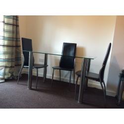 Glass table and 4 chrome and leather look chairs