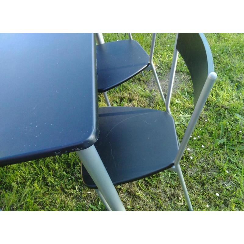 Four black chairs and table