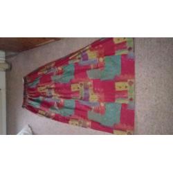 Red patterned curtains with contrasting tie-backs