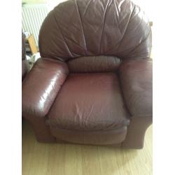 Two large burgundy leather armchairs in good condition.