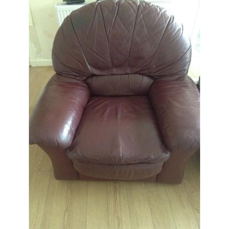 Two large burgundy leather armchairs in good condition.