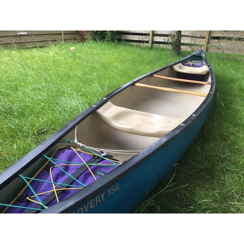 Old town canoe with river buoyancy bags and paddle