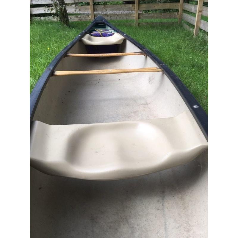 Old town canoe with river buoyancy bags and paddle